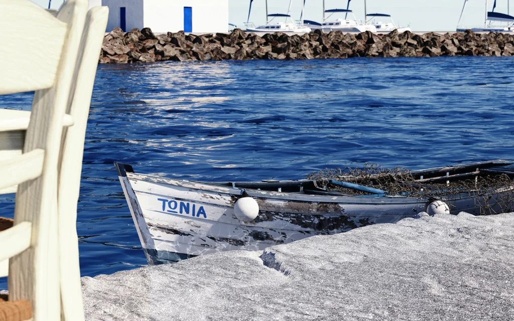 Stin Ygeia Mas old wooden boat named tonia in the sea in a greek island